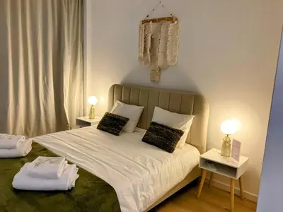 a bedroom with a large white bed with two night stands at Apartamento T2 Moderno no Centro de Faro - ML - Market Tower in Faro