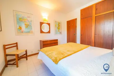 a kitchen with wooden cabinets and a sink at Balaia Mar 63D By MTPhomes in Albufeira