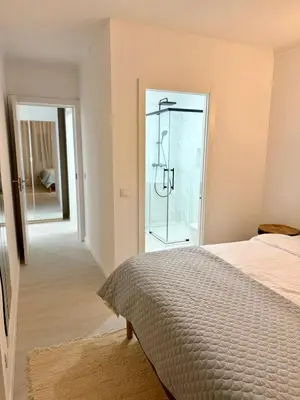 a bedroom with a bed and a glass door at Sunrise Apartment in Albufeira