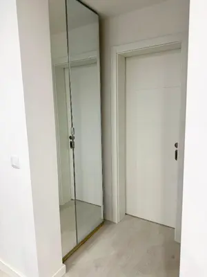 two glass doors in a room with white walls at Sunrise Apartment in Albufeira
