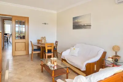 a living room with a couch and a table at Apartamento Terraços do Vale in Albufeira