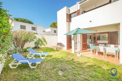 a large blue swimming pool with tables and umbrellas at Balaia Mar 63A by MTPhomes in Albufeira