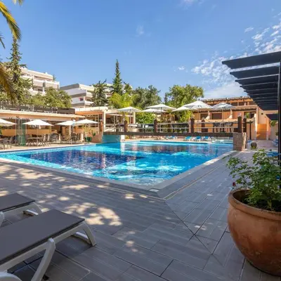 a swimming pool at a resort with tables and umbrellas at Balaia Mar 63A by MTPhomes in Albufeira
