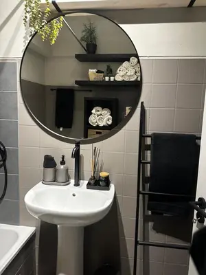 a bathroom with a sink and a mirror at Beach Holiday House T1 in Quarteira