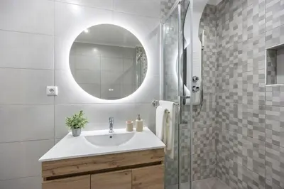 a bathroom with a sink and a mirror at Albufeira City Centre Apartment with Pool in Albufeira