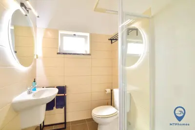 a bathroom with a toilet and a sink and a shower at Eva Andorinha 5 Pax by MTPhomes in Albufeira