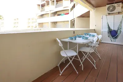 a table and chairs on the balcony of a building at Apart Palmeira Galé - Sea view - WIFI - BY BEDZY in Guia