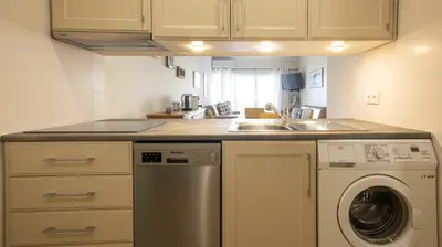 a kitchen with a sink and a washing machine at Apart Palmeira Galé - Sea view - WIFI - BY BEDZY in Guia