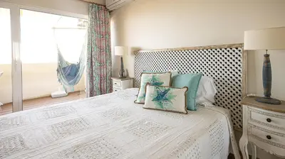a bedroom with a large bed with a window at Apart Palmeira Galé - Sea view - WIFI - BY BEDZY in Guia