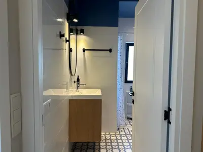 a white bathroom with a sink and a mirror at BnB Homes Ocean Breeze Terrace Apartment 400 m away from the Ocean in Albufeira