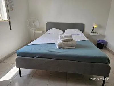 a bed with two towels on it in a bedroom at Blife Allya private apartment in FAO