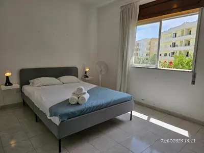 a bedroom with a bed with two towels on it at Blife Allya private apartment in FAO