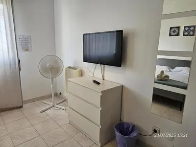 a tv on top of a dresser in a bedroom at Blife Allya private apartment in FAO