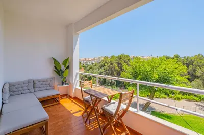a balcony with a couch and a table and chairs at Apartment Sonia in Albufeira