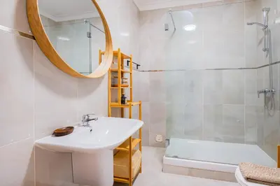 a bathroom with a sink and a shower and a mirror at Apartment Sonia in Albufeira
