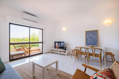 a living room with a table and chairs at Apartment Sonia in Albufeira