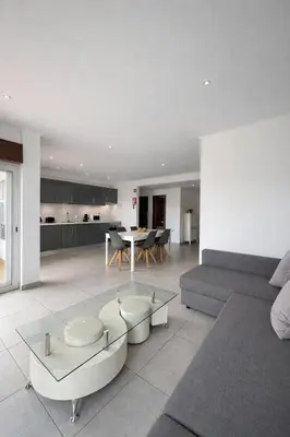 a living room with a couch and a table at Majesti Algarve Apartment in Albufeira