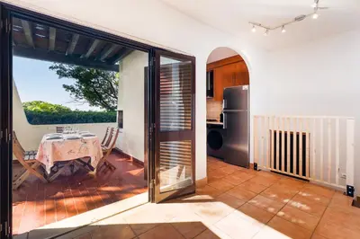 a kitchen with a table and a door to a patio at Cozy Villa next to the Golf Course by Algarve Dream Holidays in Quarteira