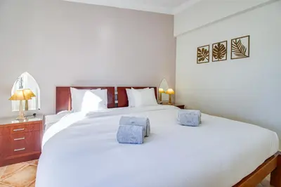 a balcony with white chairs and a view of the ocean at Duplex Apartment with Pool, Balcony, Wi-Fi & AC in Vilamoura
