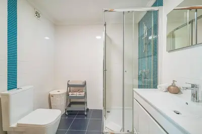 a bathroom with a shower and a toilet and a sink at Coral by MTPhomes in Albufeira