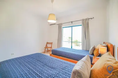 a bedroom with two beds and a mirror at Casa Joana by MTPhomes in Albufeira