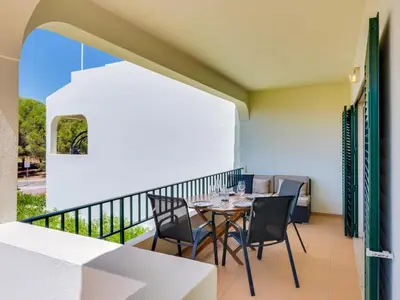 a patio with a table and chairs on a balcony at Apartamento Mélias, 2 quartos e piscina, Vilamoura in Vilamoura