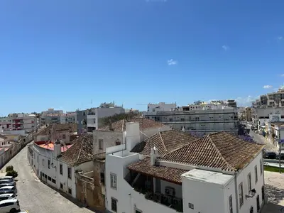 a phone hanging on a wall with a cord at 3F Bocage - Centro de Faro in Faro