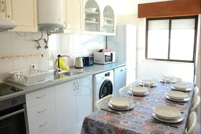 a kitchen with a table with plates on it at Blife Julya private apartment in Faro