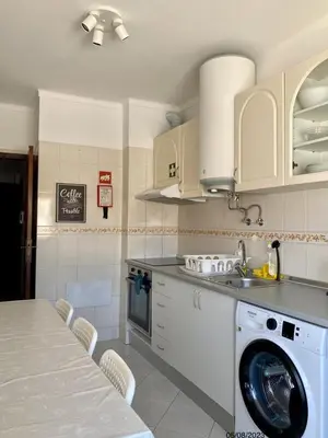 a kitchen with a washing machine and a sink at Blife Julya private apartment in Faro