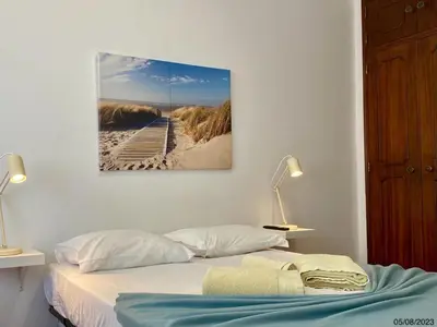 a bedroom with a bed and a painting on the wall at Blife Julya private apartment in Faro