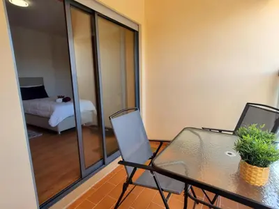 a room with a table and two chairs and a bed at Corcovada Dream Apartment in Albufeira