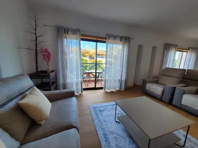 a living room with a couch and a table at Corcovada Dream Apartment in Albufeira