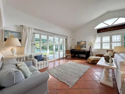 a living room with a couch and a table at Vilamoura Amazing Villa 2 With Pool by Homing in Vilamoura