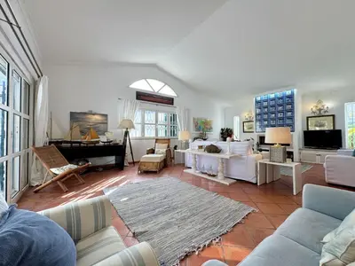 a living room with white furniture and a piano at Vilamoura Amazing Villa 2 With Pool by Homing in Vilamoura