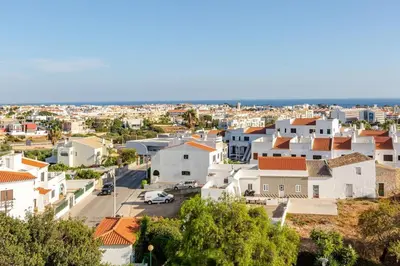 a white bathroom with a sink and a shower at Sea House Apartment - Private Condo with 4 Pools, Jacuzzi & Tennis Court in Albufeira