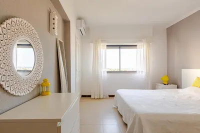 an aerial view of two tall white buildings at Sea House Apartment - Private Condo with 4 Pools, Jacuzzi & Tennis Court in Albufeira