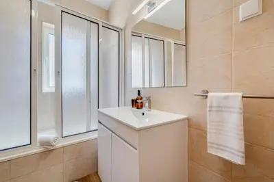 a white bathroom with a toilet and a sink at Amazing Beach Spot in Olhos de Água