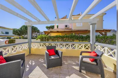 a patio with chairs and a house in the background at Villa Caly by Villa Plus in Roja- Pé