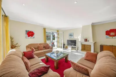 a living room with two couches and a table at Villa Caly by Villa Plus in Roja- Pé