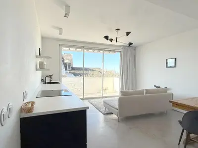 a white kitchen with a couch and a large window at 1BR with Panoramic View in historic centre Loulé in Loulé
