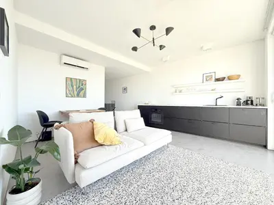 a kitchen with a couch and a table with chairs at 1BR with Panoramic View in historic centre Loulé in Loulé