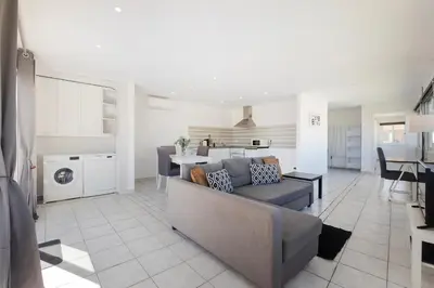 a hallway with white walls and a door with a window at Let the sun come in - walking to the beach by Algarve Dream Holidays in Albufeira