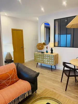 a living room with a couch and a table at Confort à Loulé in Loulé