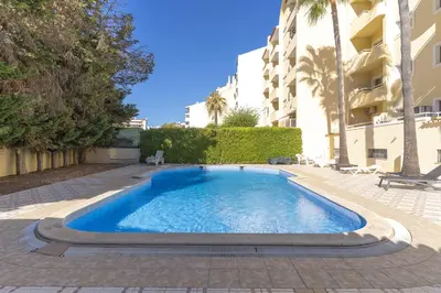 a swimming pool in the middle of a building at #344 Edificio Marina Sol by Home Holidays in Branqueira