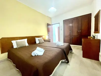 a bedroom with a large bed with towels on it at Villa Jose in Olhos de Água