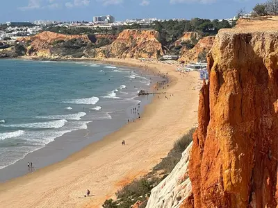 a view of a beach with people walking on the sand at Villa Jose in Olhos de Água
