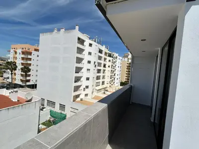 a balcony with a view of a building at Blue Coast Penthouse T4 in Quarteira