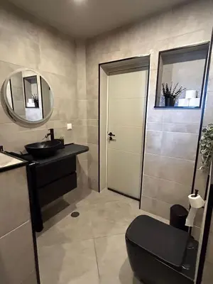 a bathroom with a toilet and a sink and a mirror at Blue Coast Penthouse T4 in Quarteira