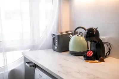 a kitchen counter with a tea kettle and a toaster at LIA - Quarteira in Quarteira