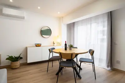 a dining room with a table and chairs at LIA - Quarteira in Quarteira